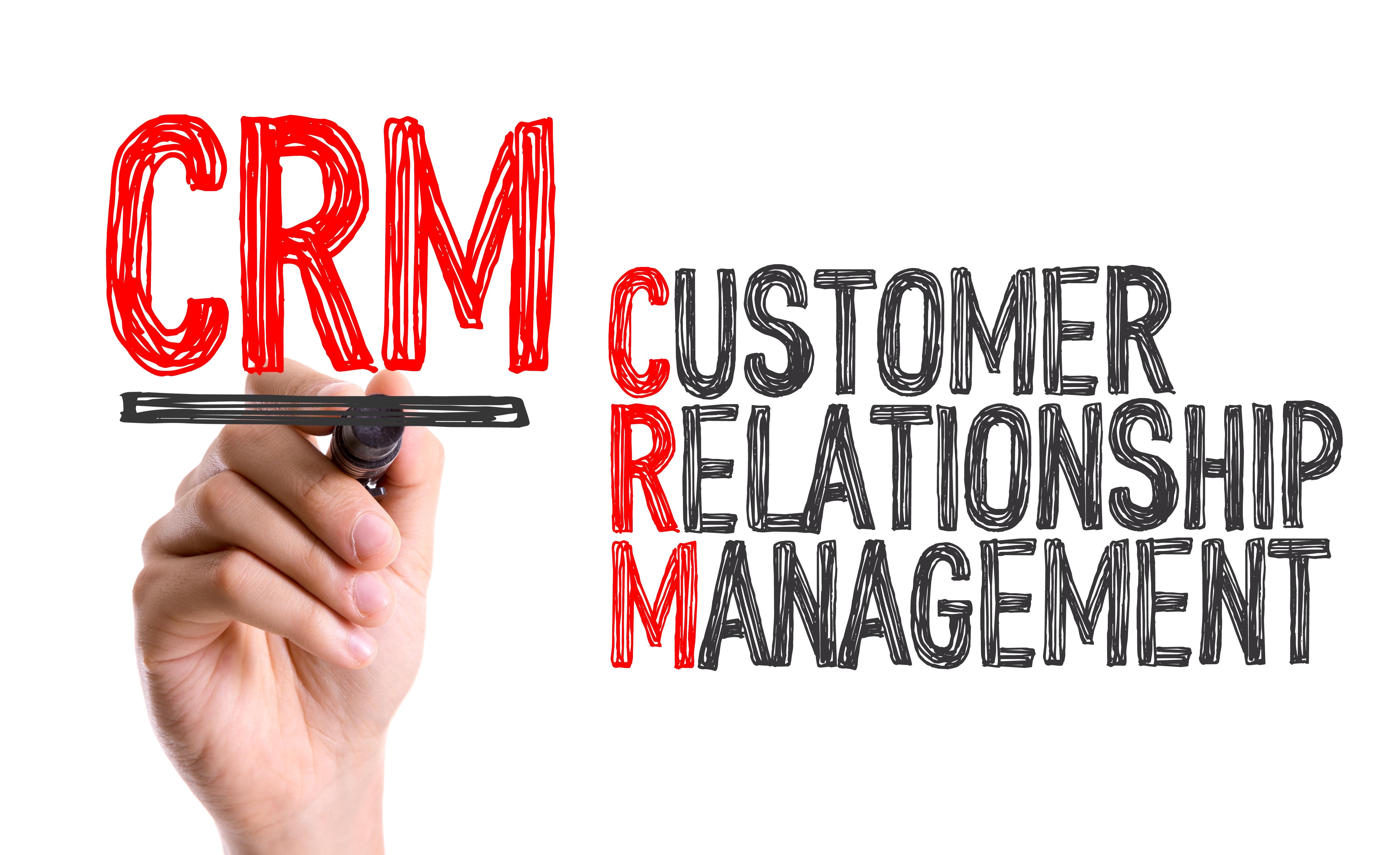 Hand with marker writing: CRM